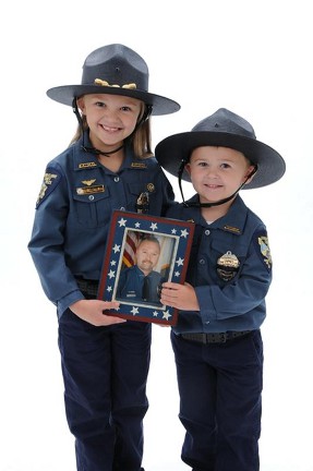 Callie and Wyatt Christian hold a picture of their father, Buddy Christian Callie and Wyatt Christian hold a picture of their father, Buddy Christian